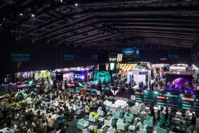 Exhibition stands and visitors at Blockchain Life