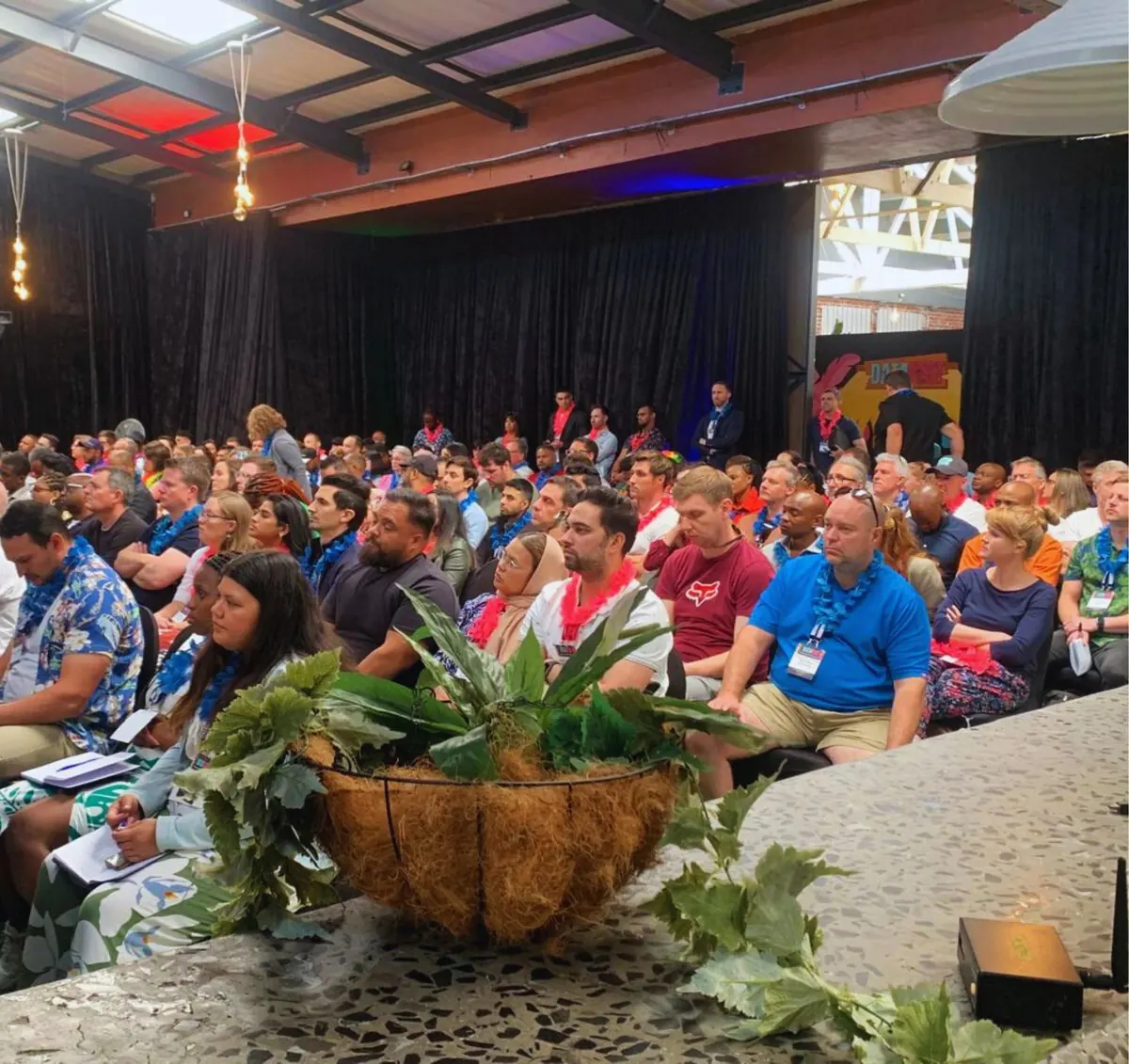 Audience seated in a conference hall in the AiFest organiser gallery