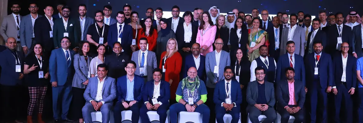 Delegates posing together at an AINext conference