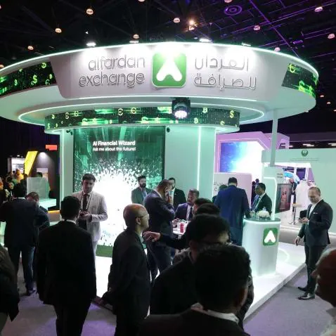 Visitors speaking with exhibitors at a Dubai AI Festival exhibition stand